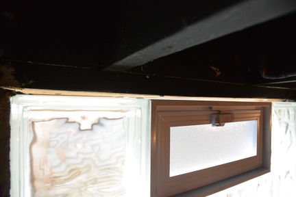 Small gap at top between window and wooden house frame